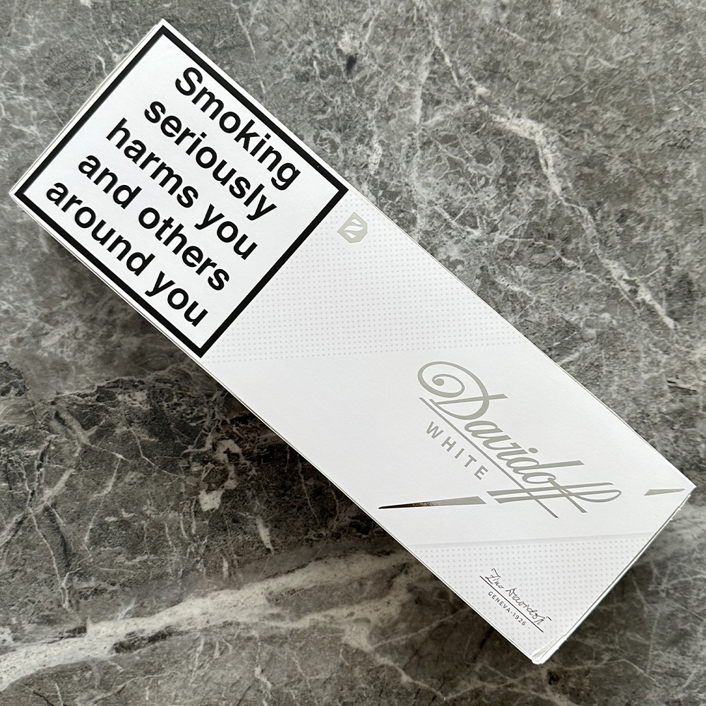 Angled close-up of Davidoff Gold cigarette pack showing the warmer gold packaging tone and slim format